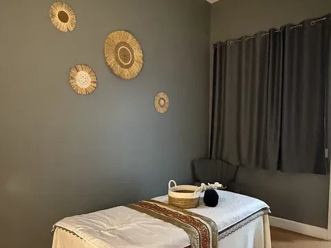 A treatment room at Millions Sense Thai Massage with a massage table and soft lighting